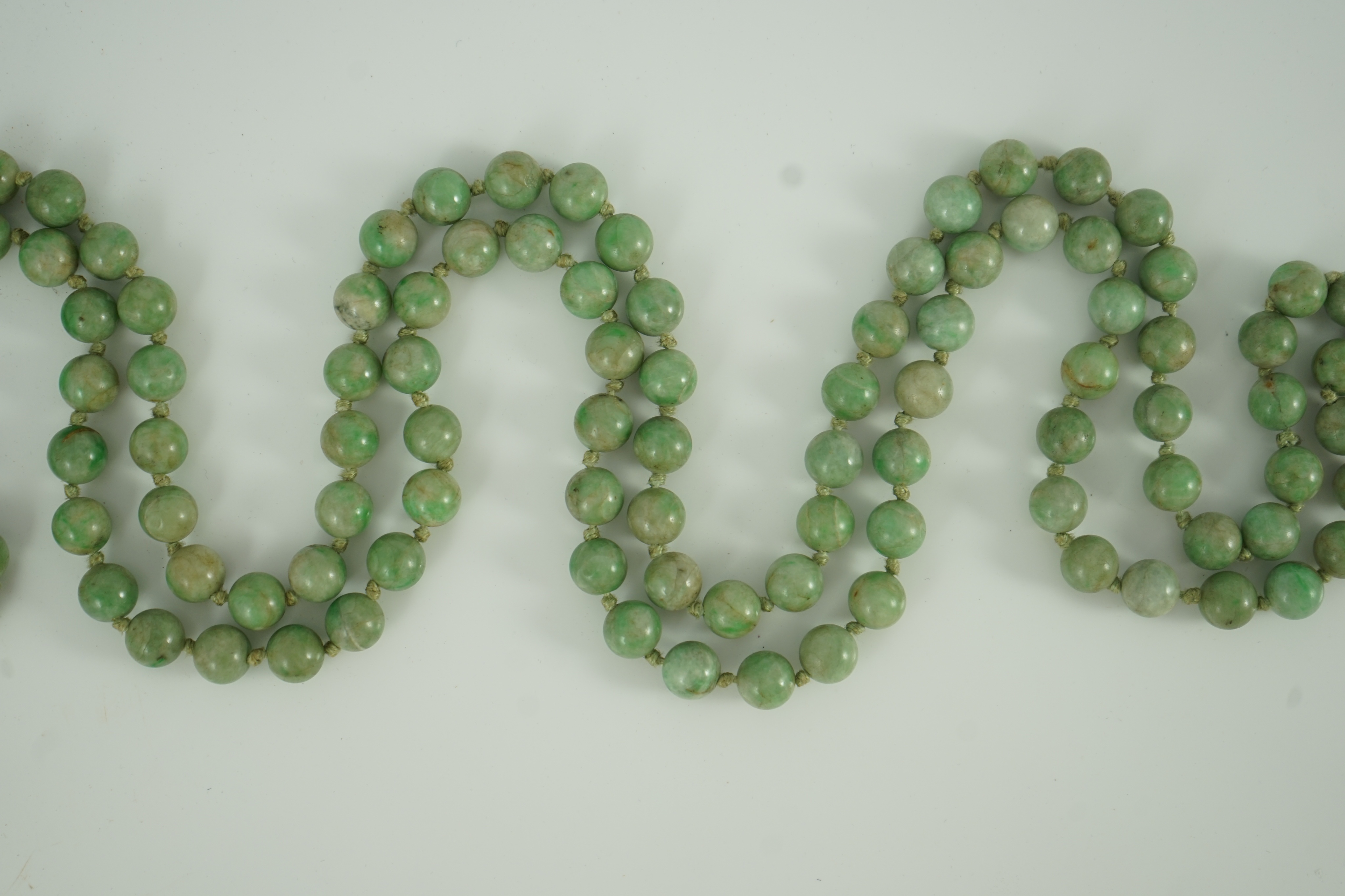 A Chinese jadeite pendant and jadeite beads, 19th century, Pendant 3.9 cm, total drop 68 cm